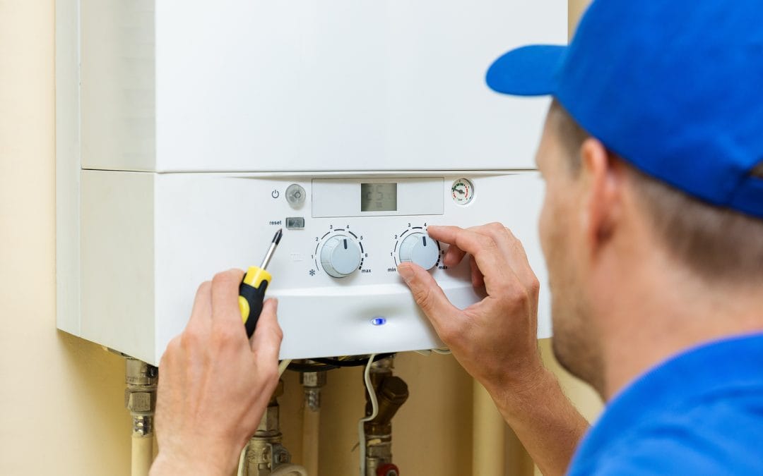 emergency boiler repair - worker set up central gas heating boile